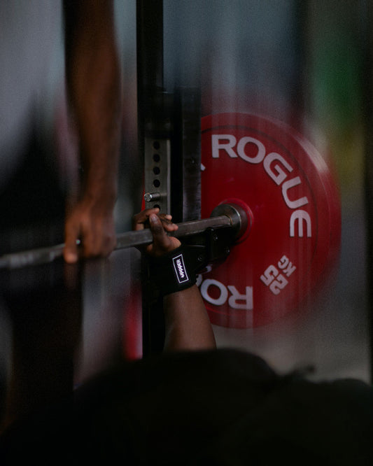 Man bench pressing with uppper wrist wraps