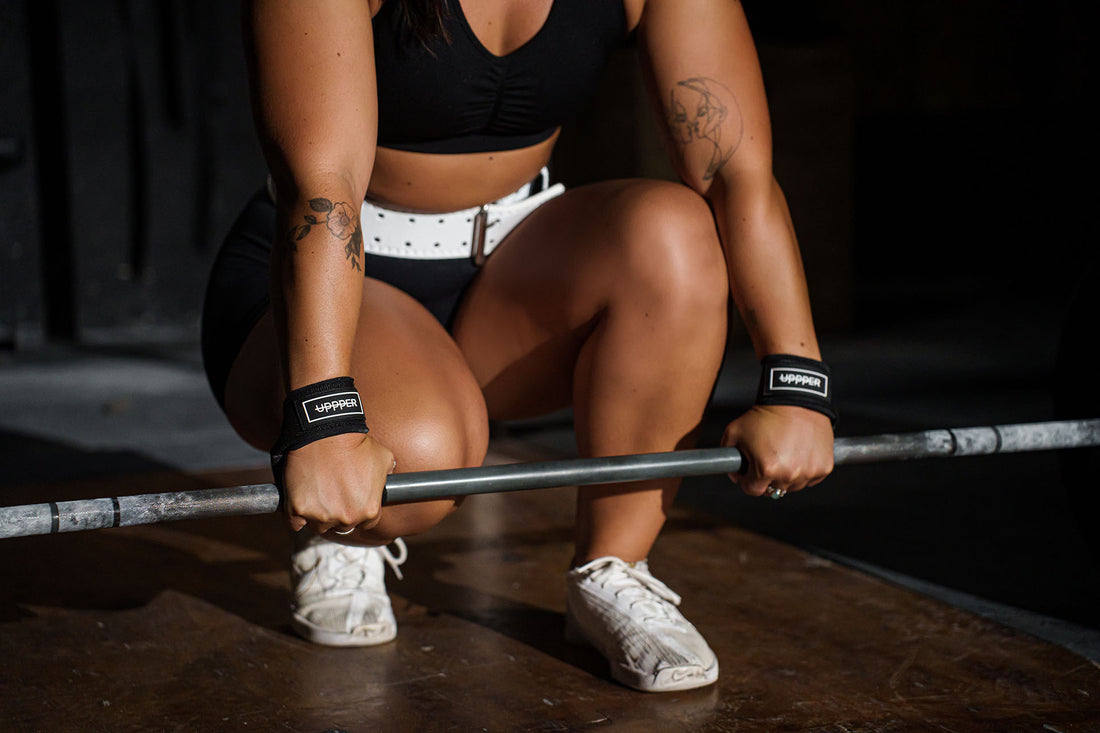 woman gripping barbell