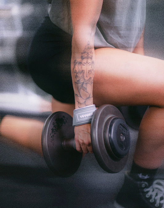 woman doing lunges with lifting straps